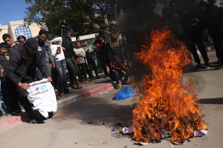 Palestinians burn ‘humiliating’ shirts after release from Israeli prisons